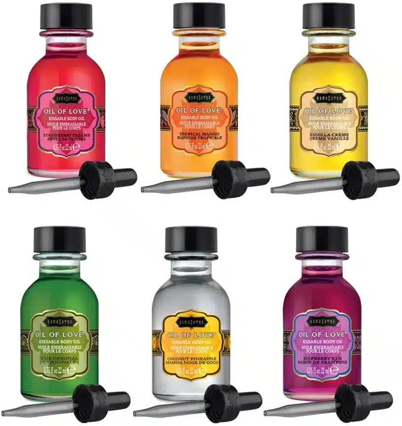 six glass bottles with droppers in front of them with differing colored and scented oils in them